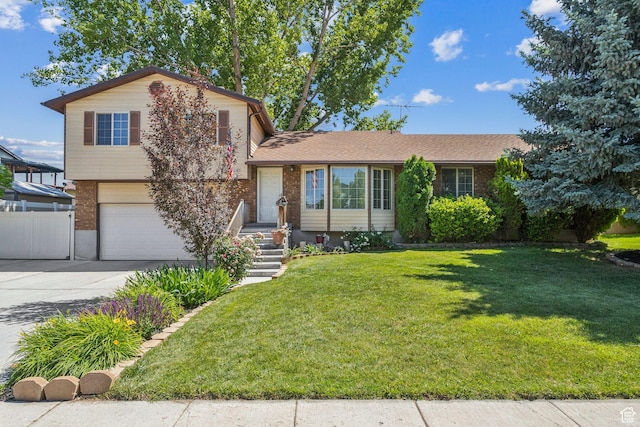 3285 W 6775 S, West Jordan, UT 84084 - tri-level home with a garage, brick siding, and driveway
