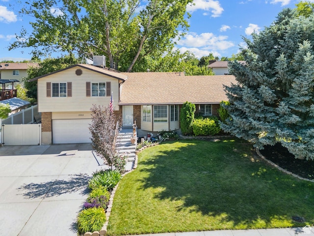 3285 W 6775 S, West Jordan, UT 84084 - split level home with a garage, driveway, brick siding, and a chimney