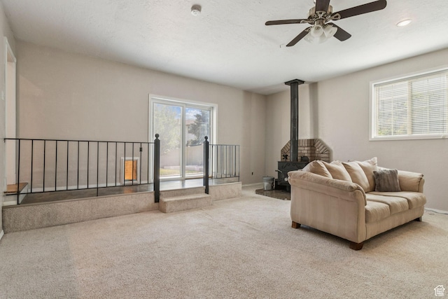 3285 W 6775 S, West Jordan, UT 84084 - living area featuring a wood stove, carpet, a ceiling fan, and recessed lighting