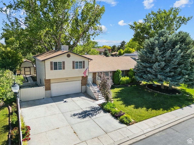 3285 W 6775 S, West Jordan, UT 84084 - tri-level home with an attached garage, concrete driveway, a front lawn, and brick siding