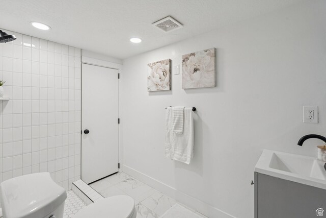 213 E 500 N, Nephi, UT 84648 - bathroom featuring marble finish flooring, vanity, and recessed lighting