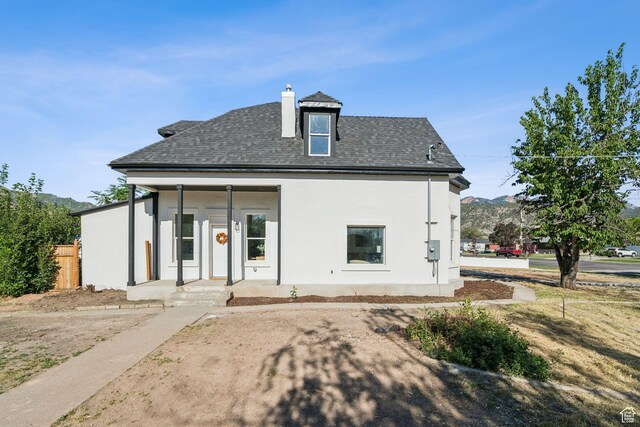 213 E 500 N, Nephi, UT 84648 - rear view of house with stucco siding, roof with shingles, and a chimney