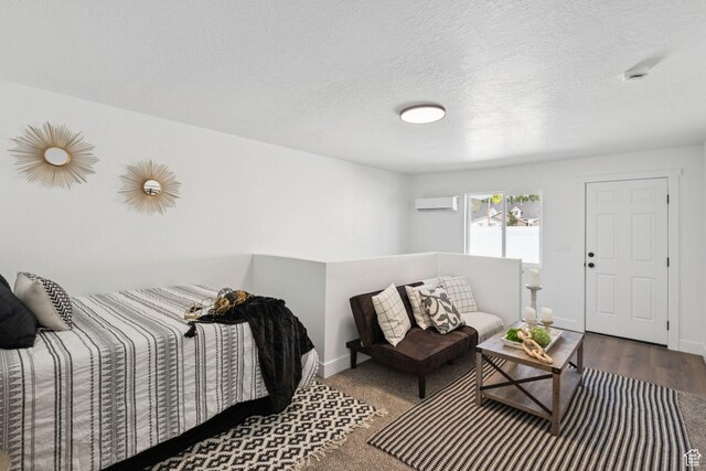 213 E 500 N, Nephi, UT 84648 - living room with an AC wall unit, wood finished floors, and a textured ceiling