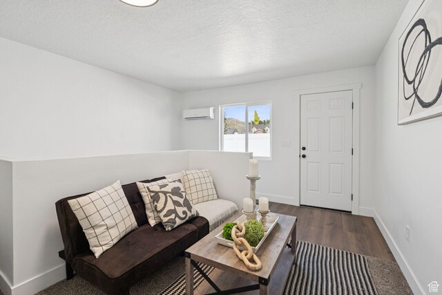 213 E 500 N, Nephi, UT 84648 - living room featuring a wall mounted air conditioner, wood finished floors, and a textured ceiling