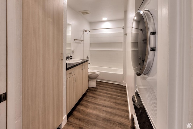 443 W Kane Creek Blvd Unit A104, Moab, UT 84532 - bathroom featuring stacked washing machine and dryer, vanity, bathing tub / shower combination, and wood finished floors