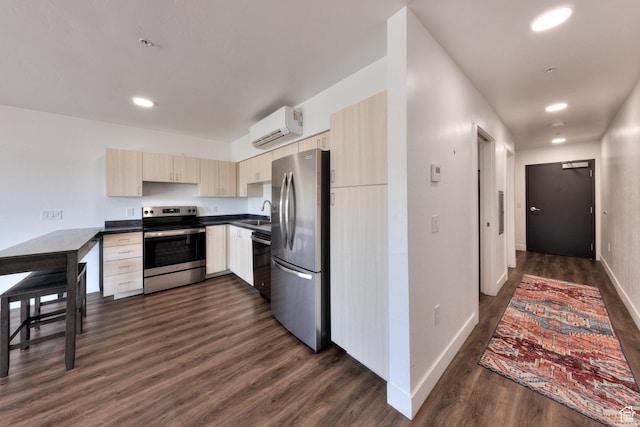443 W Kane Creek Blvd Unit A104, Moab, UT 84532 - kitchen featuring appliances with stainless steel finishes, an AC wall unit, light brown cabinets, dark countertops, and dark wood-type flooring