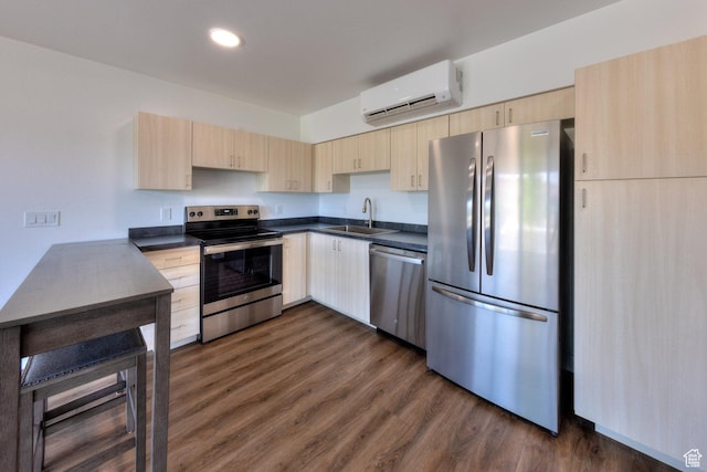 443 W Kane Creek Blvd Unit A104, Moab, UT 84532 - kitchen with stainless steel appliances, light brown cabinetry, a wall mounted air conditioner, dark countertops, and recessed lighting