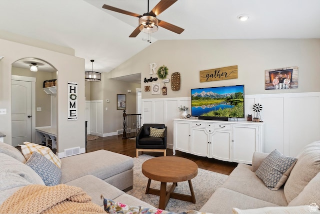 1412 S 4175 W, Syracuse, UT 84075 - living area featuring a ceiling fan, dark wood-type flooring, a wainscoted wall, lofted ceiling, and arched walkways