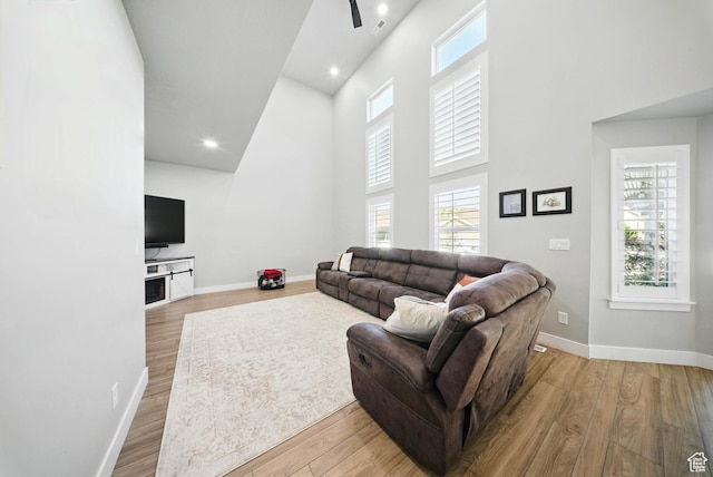4888 W Transcendent Ct, West Jordan, UT 84081 - living room with a high ceiling, healthy amount of natural light, wood finished floors, ceiling fan, and recessed lighting