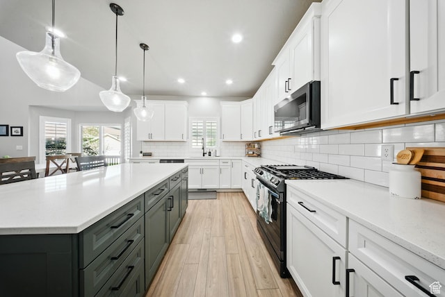 4888 W Transcendent Ct, West Jordan, UT 84081 - kitchen featuring stainless steel microwave, black range with gas cooktop, gray cabinetry, white cabinetry, and recessed lighting