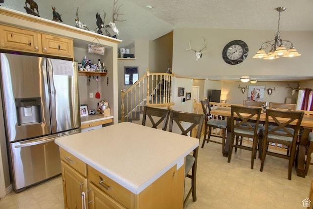 2595 W 4000 S, Roy, UT 84067 - kitchen featuring stainless steel refrigerator with ice dispenser, vaulted ceiling, light countertops, light floors, and a center island