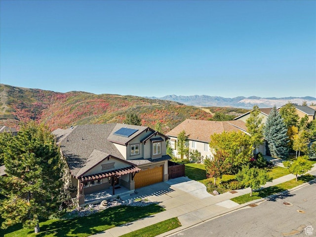 1794 E Longbranch Dr, Draper, UT 84020 - view of front of house featuring a garage, driveway, solar panels, and a mountain view