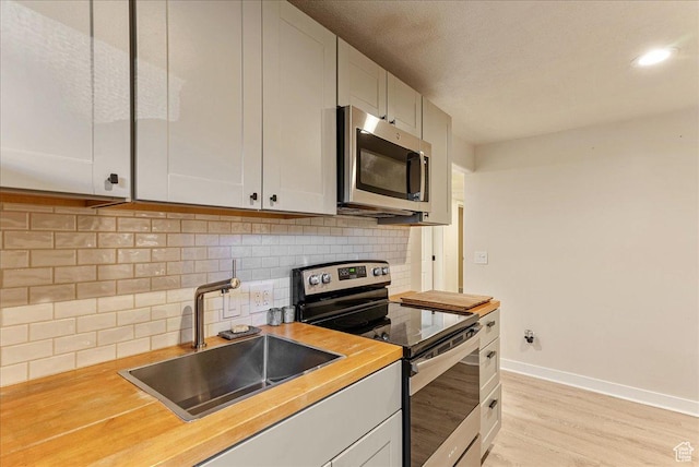 1794 E Longbranch Dr, Draper, UT 84020 - kitchen featuring appliances with stainless steel finishes, light wood finished floors, and decorative backsplash