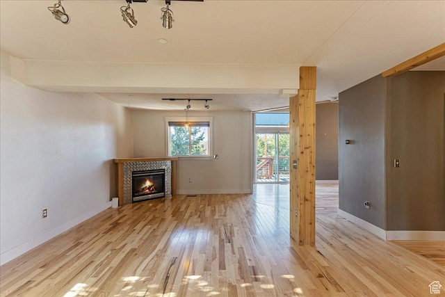 1794 E Longbranch Dr, Draper, UT 84020 - unfurnished living room featuring light wood-type flooring, a tile fireplace, and track lighting