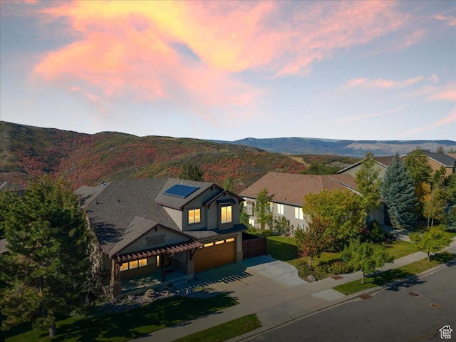 1794 E Longbranch Dr, Draper, UT 84020 - view of front facade featuring a garage, driveway, solar panels, and a mountain view