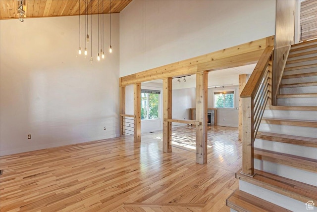 1794 E Longbranch Dr, Draper, UT 84020 - unfurnished living room with stairs, light wood-style flooring, and wooden ceiling
