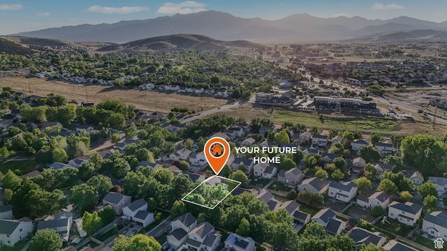 7839 N Apache Ln E, Eagle Mountain, UT 84005 - aerial view of property and surrounding area featuring a mountainous background, property parcel outlined, and nearby suburban area