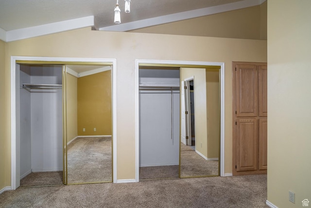 301 S 1200 E Unit 64, St George, UT 84790 - unfurnished bedroom featuring carpet, two closets, and lofted ceiling