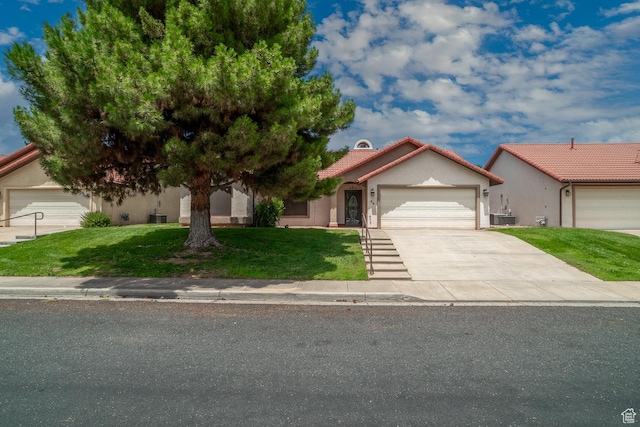 301 S 1200 E Unit 64, St George, UT 84790 - view of front of home with a garage, a front lawn, concrete driveway, a tiled roof, and stucco siding