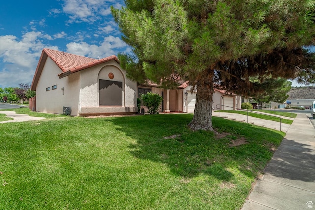 301 S 1200 E Unit 64, St George, UT 84790 - mediterranean / spanish-style home with stucco siding, a front lawn, a tile roof, concrete driveway, and an attached garage