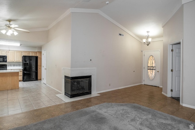 301 S 1200 E Unit 64, St George, UT 84790 - unfurnished living room featuring light tile patterned flooring, vaulted ceiling, ceiling fan, a multi sided fireplace, and a chandelier