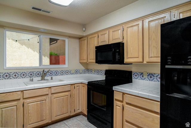 301 S 1200 E Unit 64, St George, UT 84790 - kitchen featuring black appliances, backsplash, light tile patterned floors, and light brown cabinets