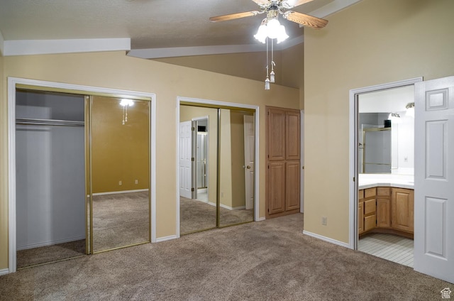 301 S 1200 E Unit 64, St George, UT 84790 - unfurnished bedroom featuring multiple closets, carpet floors, lofted ceiling, ensuite bath, and a ceiling fan