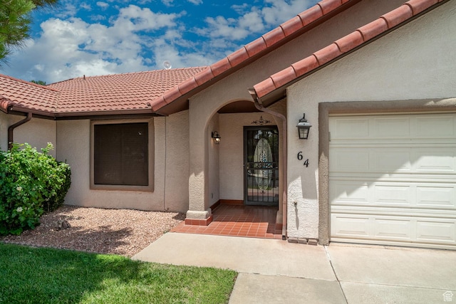 301 S 1200 E Unit 64, St George, UT 84790 - doorway to property featuring stucco siding, a tiled roof, and a garage