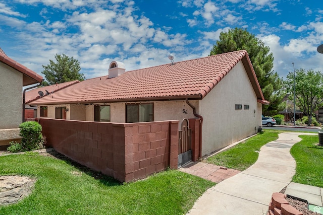 301 S 1200 E Unit 64, St George, UT 84790 - back of house featuring a chimney, a tiled roof, stucco siding, and a gate