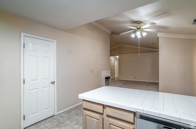 301 S 1200 E Unit 64, St George, UT 84790 - kitchen with stainless steel dishwasher, tile counters, ceiling fan, light brown cabinetry, and a textured ceiling