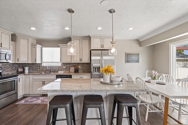 1673 W 9775 S, South Jordan, UT 84095 - kitchen featuring appliances with stainless steel finishes, a kitchen breakfast bar, dark wood-style floors, a kitchen island, and backsplash
