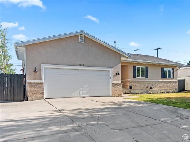 1673 W 9775 S, South Jordan, UT 84095 - ranch-style home featuring brick siding, stucco siding, an attached garage, and concrete driveway