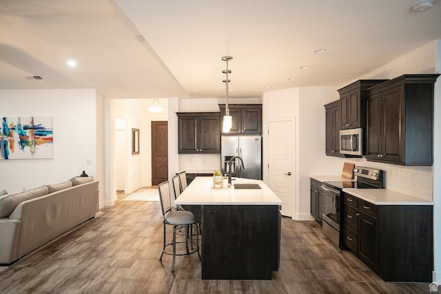 1060 N Ocotillo Dr, Washington, UT 84780 - kitchen featuring appliances with stainless steel finishes, open floor plan, tasteful backsplash, dark wood finished floors, and light countertops
