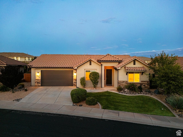 1060 N Ocotillo Dr, Washington, UT 84780 - mediterranean / spanish-style house featuring stone siding, a tiled roof, stucco siding, driveway, and an attached garage