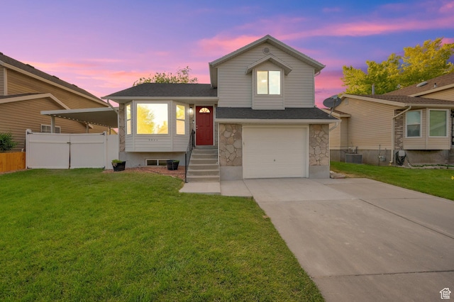 3042 W 8565 S, West Jordan, UT 84088 - tri-level home featuring stone siding, an attached garage, driveway, and a shingled roof