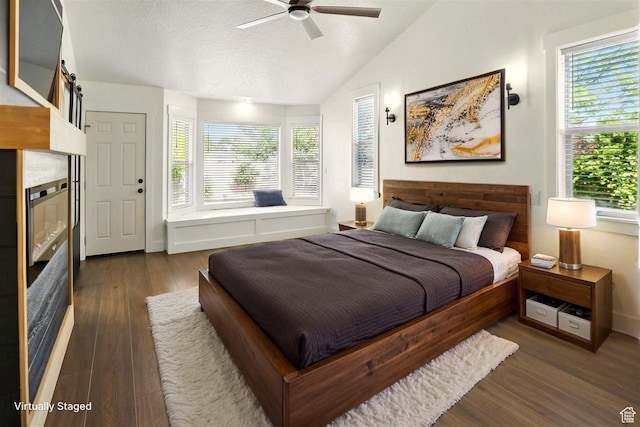 7414 S Regal Dr, West Jordan, UT 84081 - bedroom featuring dark wood-style flooring, lofted ceiling, a textured ceiling, and ceiling fan