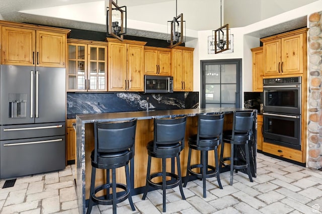 7414 S Regal Dr, West Jordan, UT 84081 - kitchen with appliances with stainless steel finishes, dark countertops, decorative backsplash, and a center island