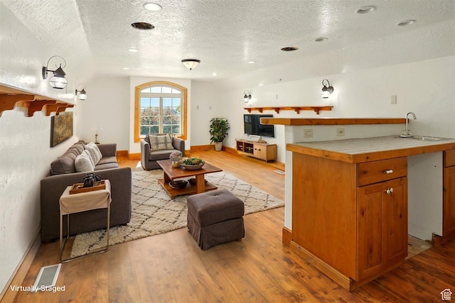 7414 S Regal Dr, West Jordan, UT 84081 - living area featuring a textured ceiling and wood finished floors