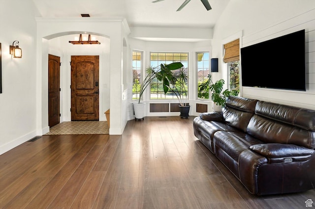 7414 S Regal Dr, West Jordan, UT 84081 - living area featuring dark wood-style flooring, ceiling fan, healthy amount of natural light, and arched walkways