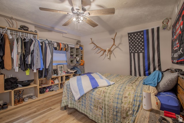 1211 E Spring Ridge Dr S, Sandy, UT 84094 - bedroom with a textured ceiling, wood finished floors, ceiling fan, and a closet