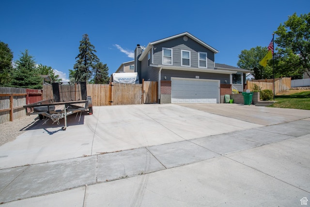 1211 E Spring Ridge Dr S, Sandy, UT 84094 - view of front facade with brick siding, a garage, and a chimney