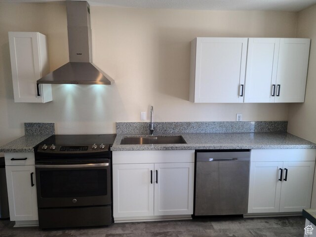 48 N Main St, Ephraim, UT 84627 - kitchen with electric range oven, wall chimney exhaust hood, dishwasher, and white cabinetry