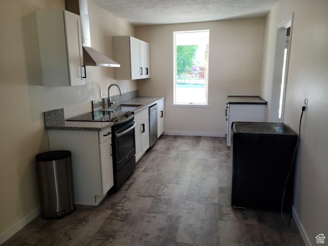48 N Main St, Ephraim, UT 84627 - kitchen with black range with electric stovetop, stainless steel dishwasher, white cabinetry, wall chimney range hood, and a textured ceiling