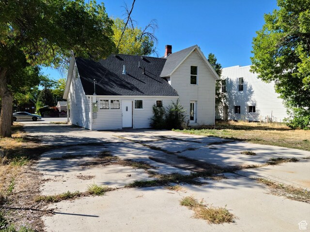 48 N Main St, Ephraim, UT 84627 - back of property featuring concrete driveway, a chimney, and a shingled roof
