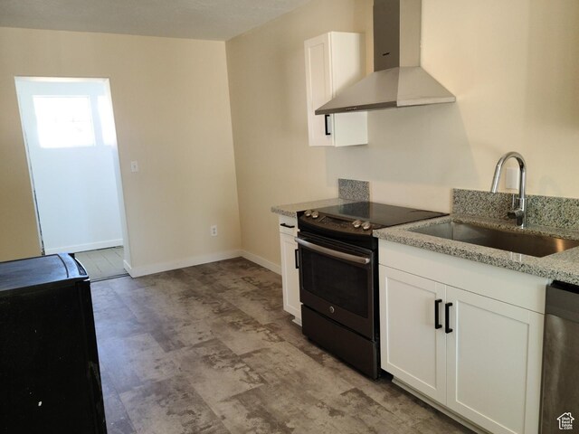 48 N Main St, Ephraim, UT 84627 - kitchen featuring wall chimney exhaust hood, black range with electric stovetop, dishwasher, light stone counters, and white cabinetry