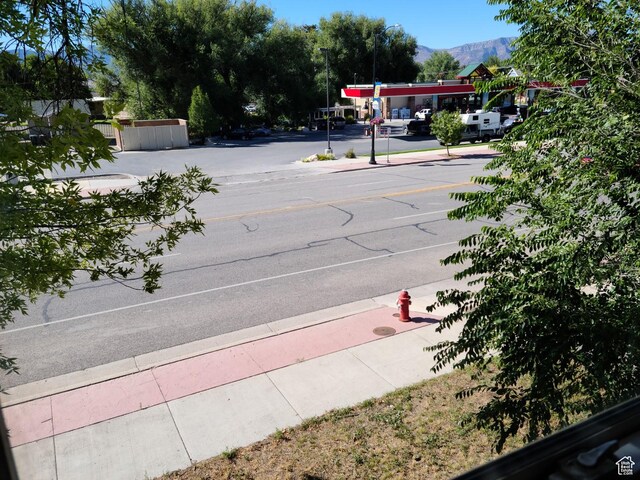 48 N Main St, Ephraim, UT 84627 - view of asphalt street with sidewalks, curbs, a mountain view, and street lights