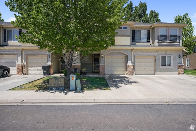 211 Greenfield Cir Unit 119, Heber City, UT 84032 - view of property featuring stucco siding, driveway, stone siding, and a garage