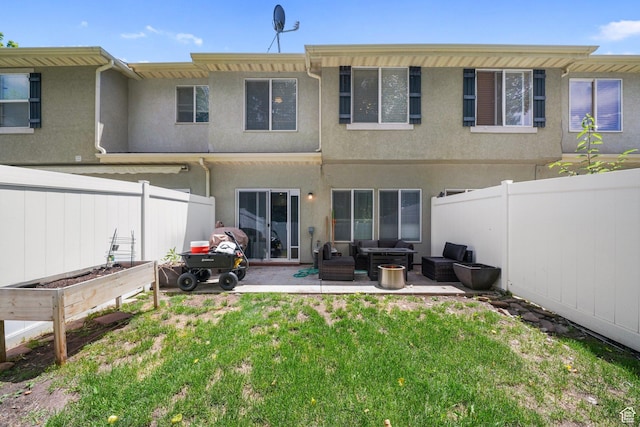 211 Greenfield Cir Unit 119, Heber City, UT 84032 - rear view of house with outdoor lounge area, a garden, stucco siding, and a fenced backyard