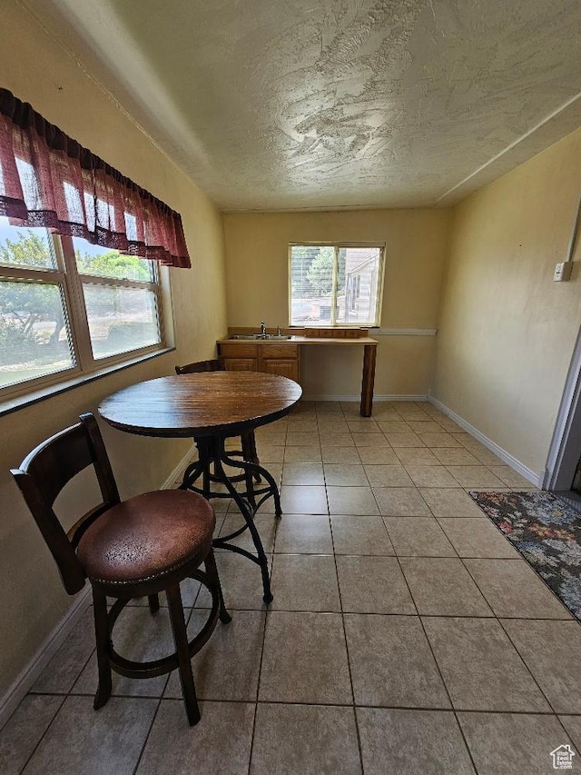 675 W 3300 N, Vernal, UT 84078 - dining room featuring healthy amount of natural light, a textured ceiling, and light tile patterned flooring