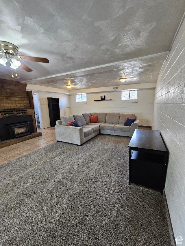 675 W 3300 N, Vernal, UT 84078 - living area featuring healthy amount of natural light, a large fireplace, a ceiling fan, concrete block wall, and a textured ceiling